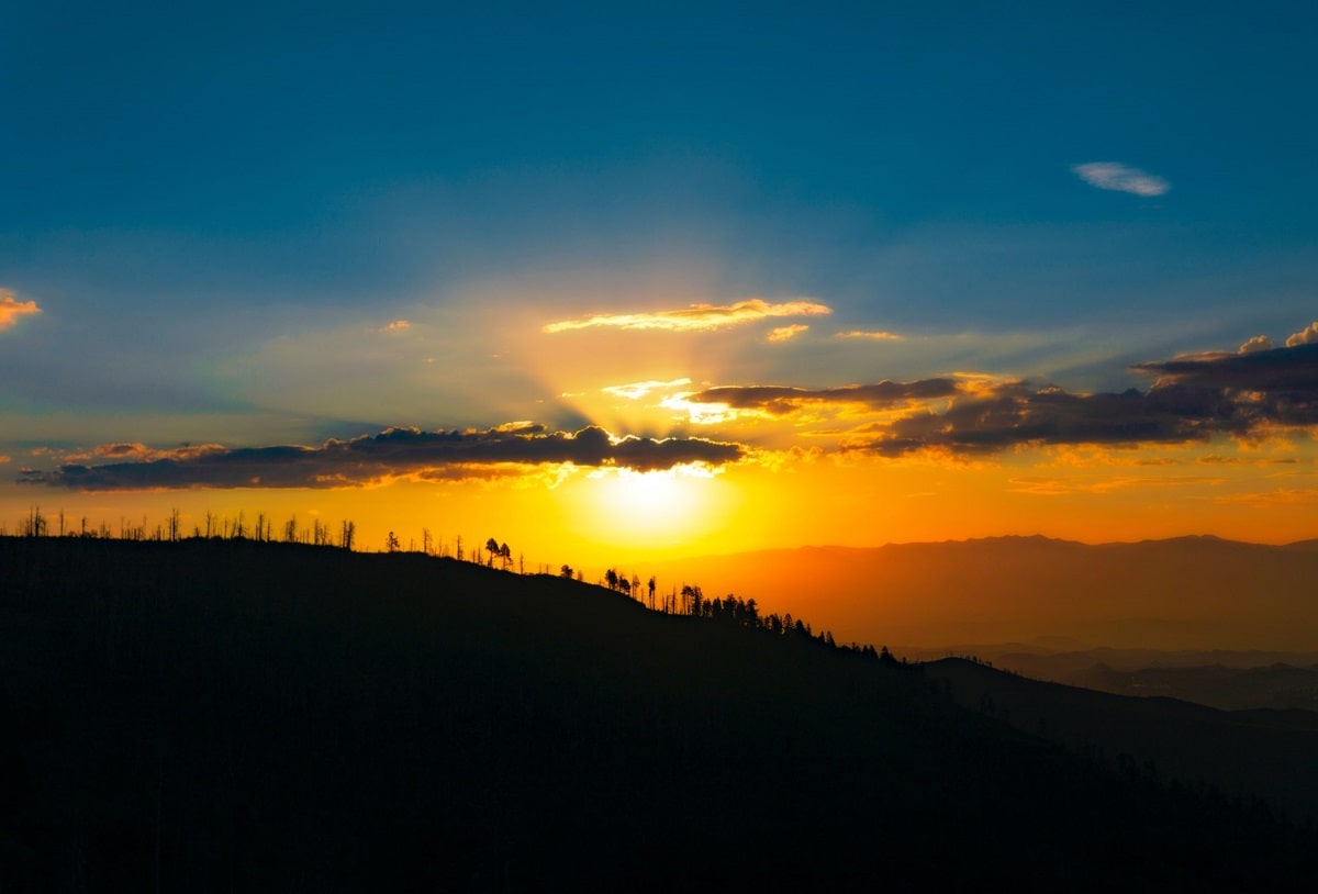 Image of a sunset on a windy hill