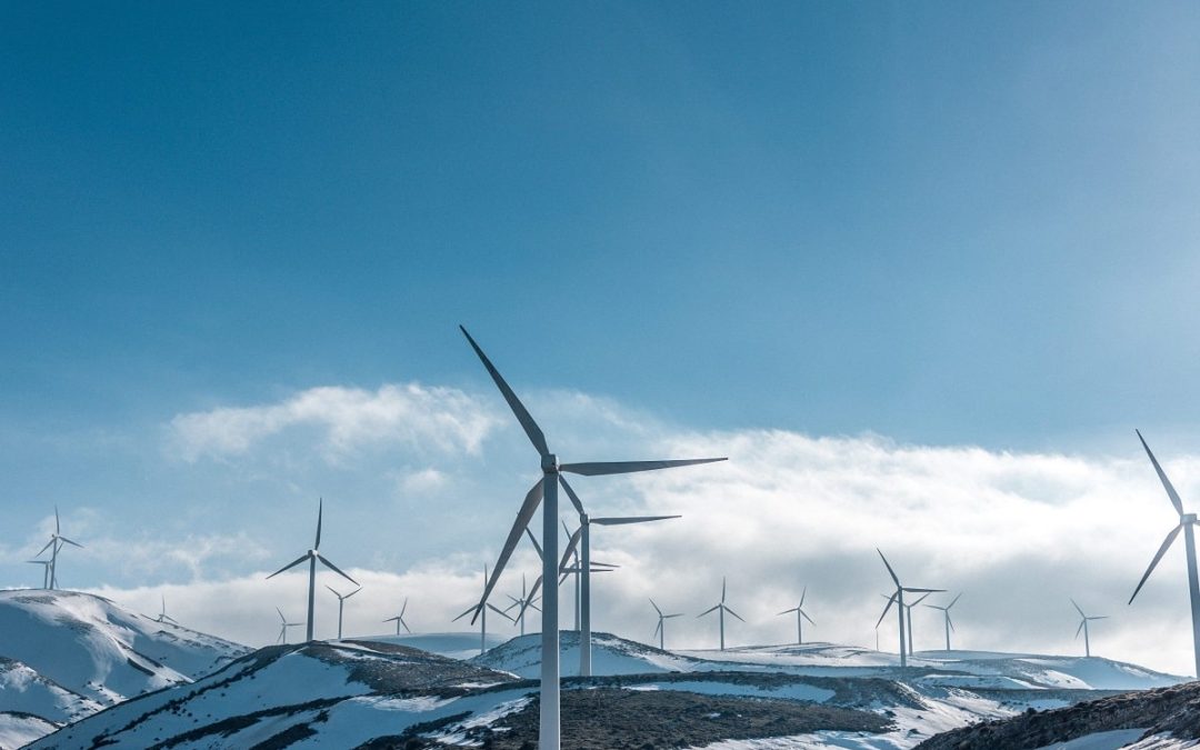 Wind turbines on hills covered with snow